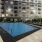 a large building with a pool in front of it