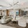 a large lounge with a large chandelier and seating