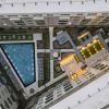 an aerial view  of a courtyard and pool