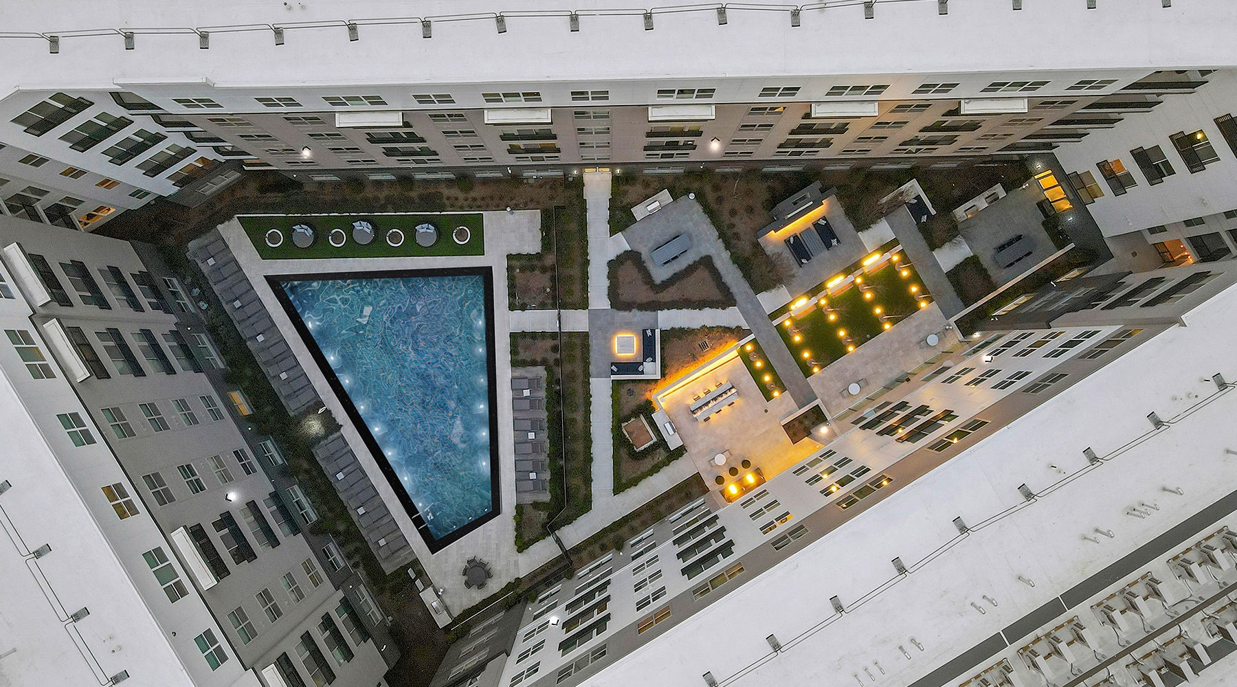 an aerial view  of a courtyard and pool