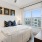 a bedroom with a bed and large window