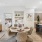 a large living room with a tv table and chairs